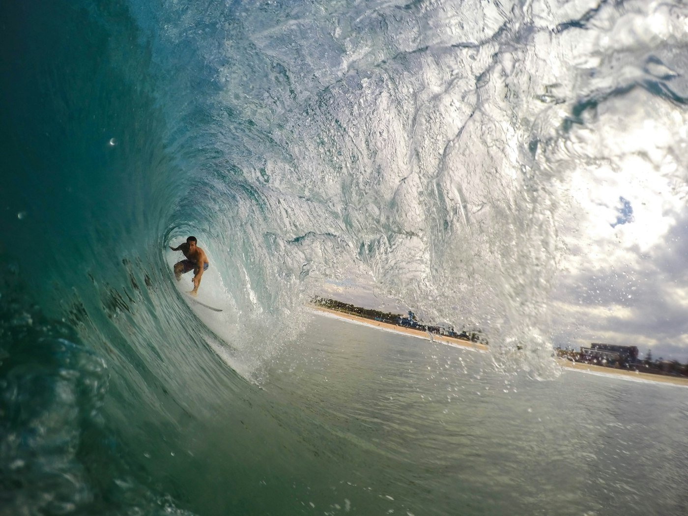 Surfer deep inside a green barrel