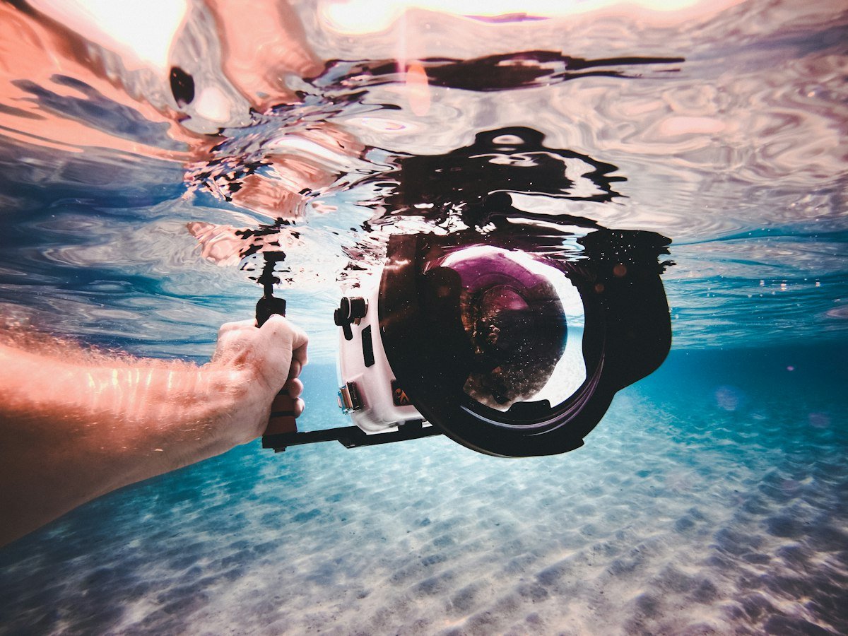 Camera in its water housing, half under the surface