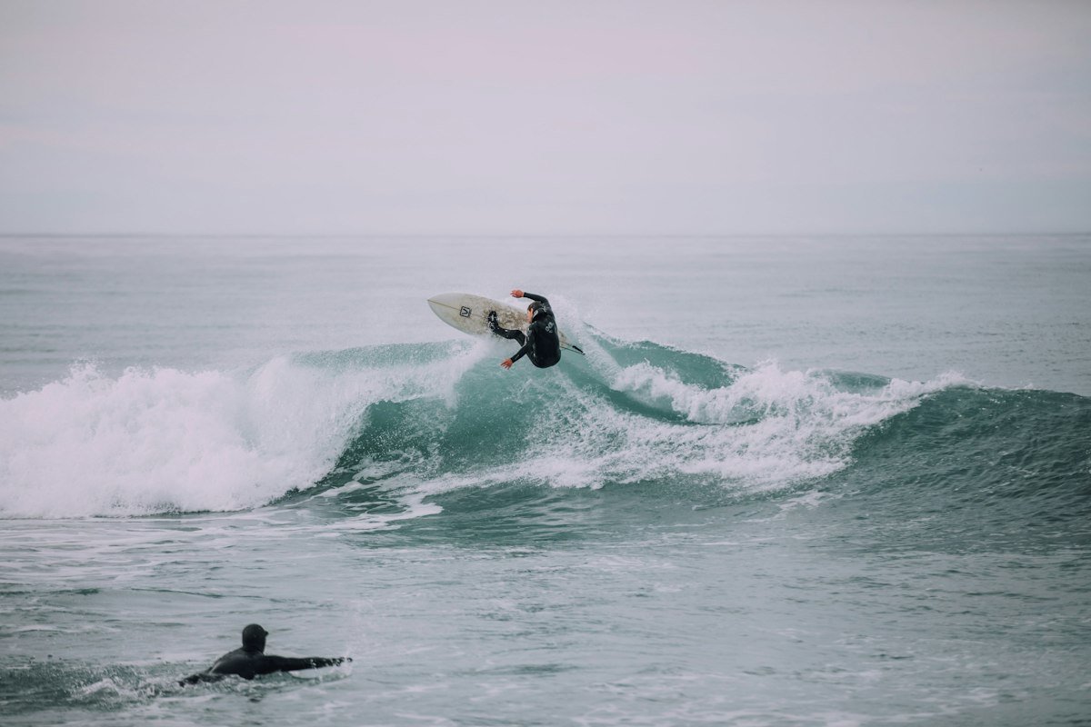Surfer turning on a grey morning wave