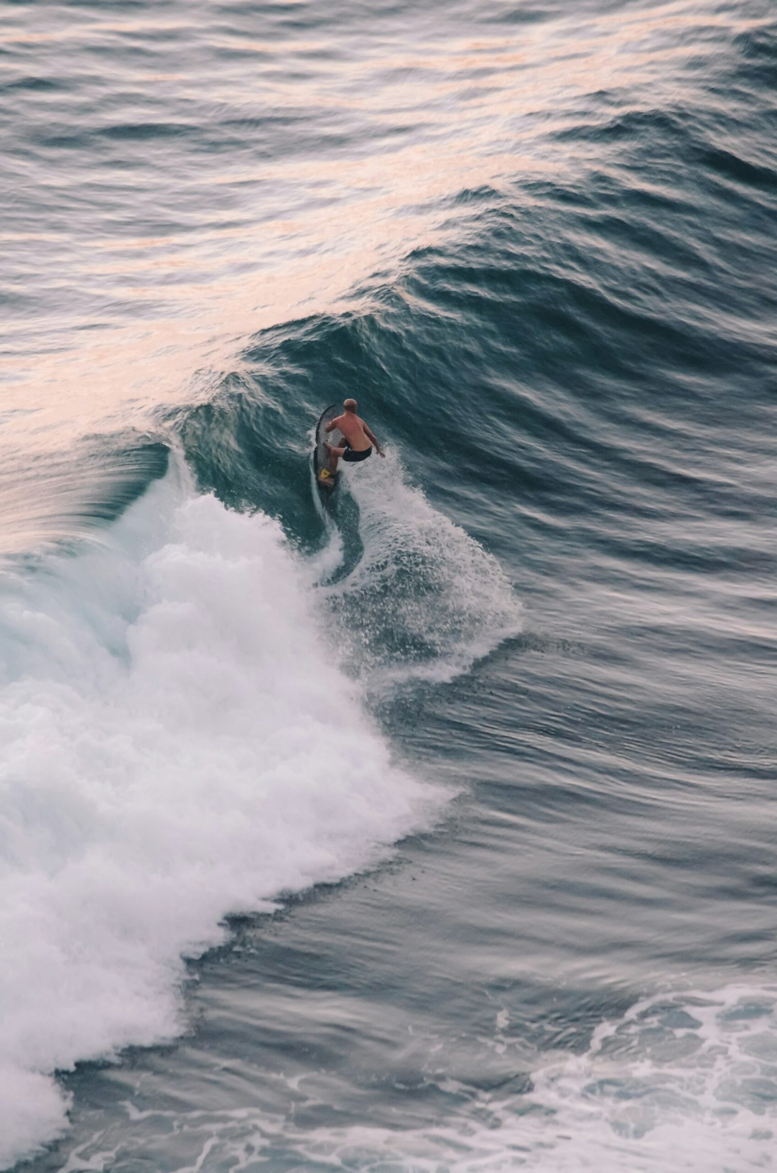Surfer carving through the spray of a wave