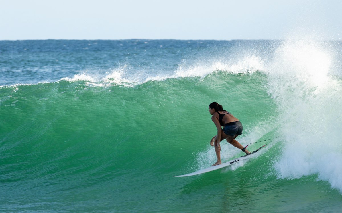 Surfer carving on a clean wave