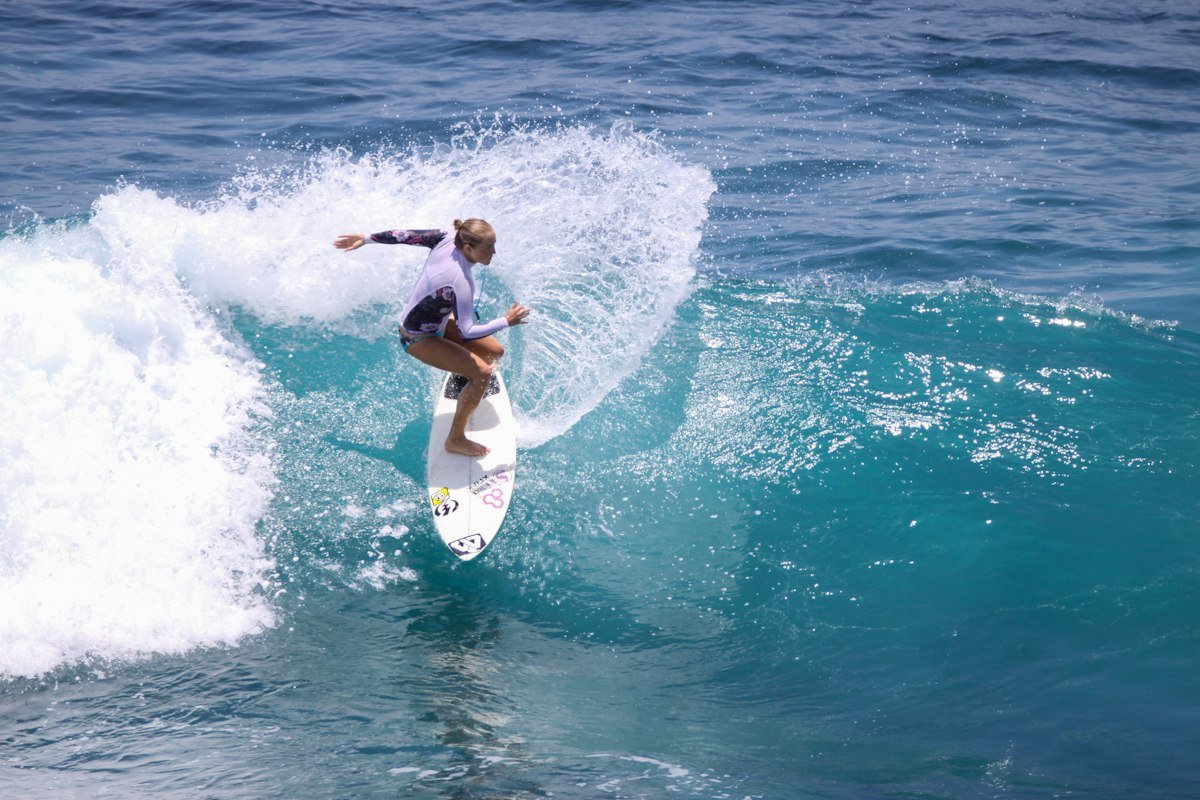 Surfer throwing spray off the top of a wave