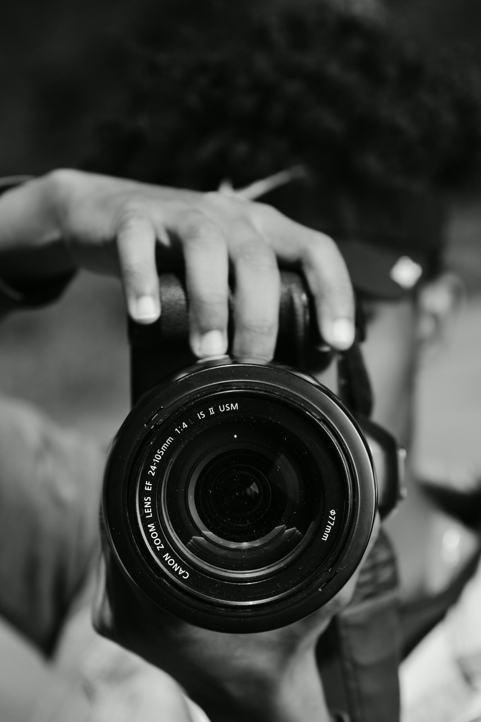 Hands holding a camera lens