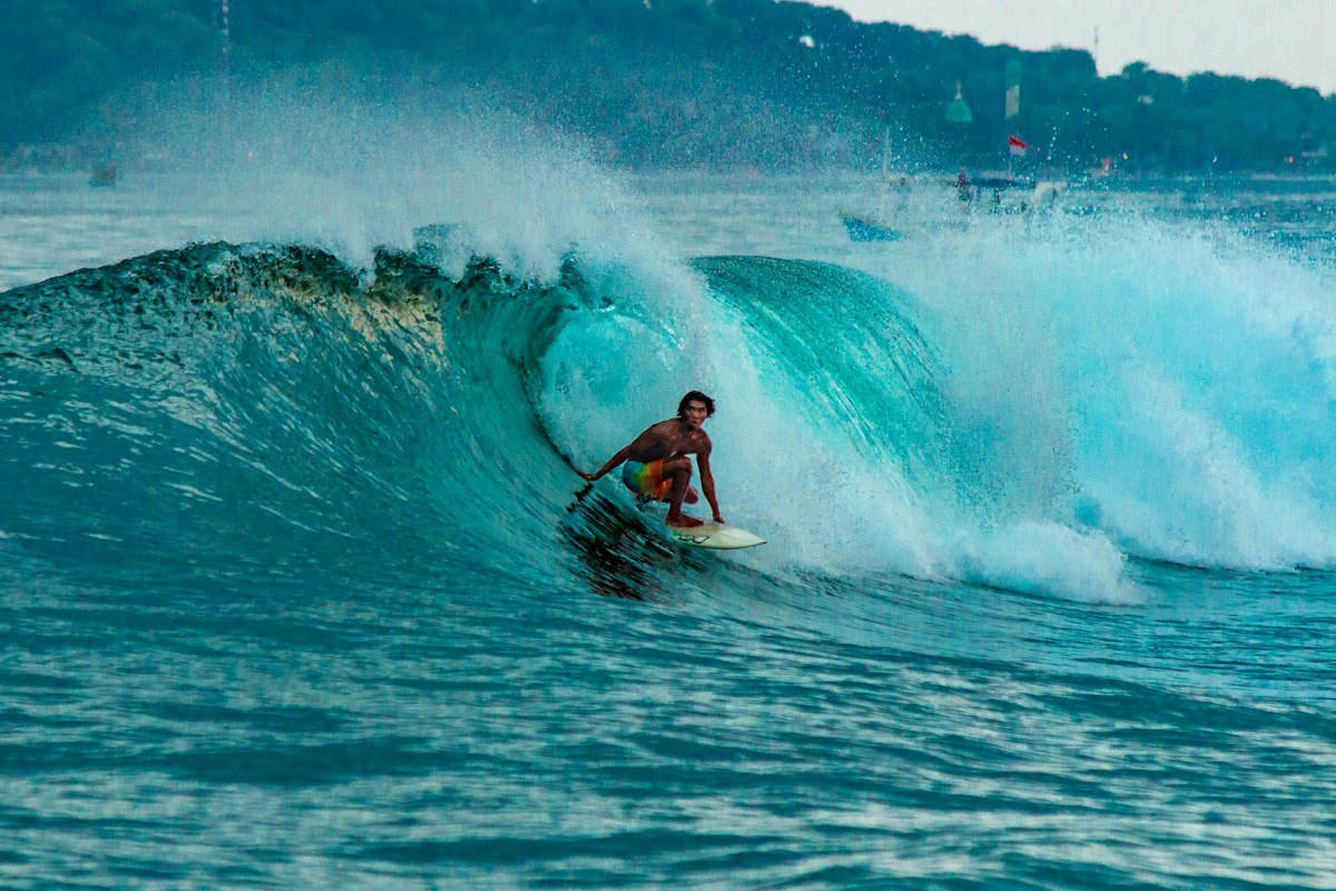 Surfer driving through a turquoise barrel