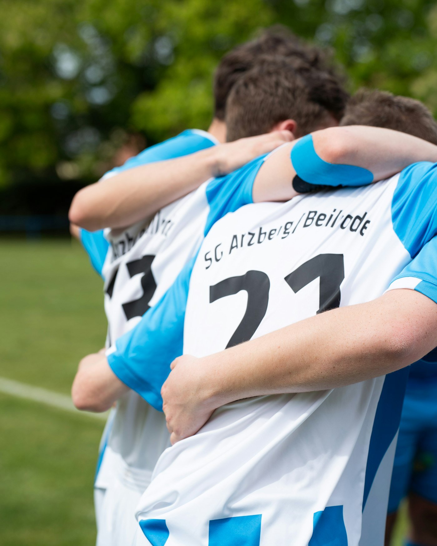 Football players hugging to celebrate a goal