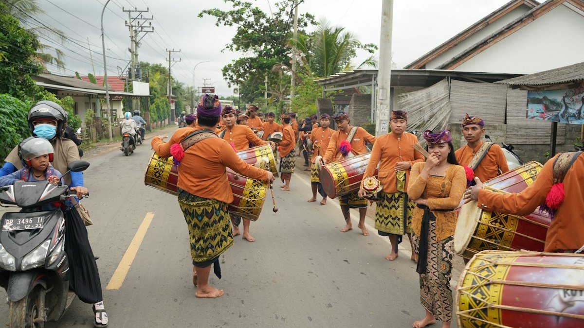 People in traditional clothes walking in procession on the road