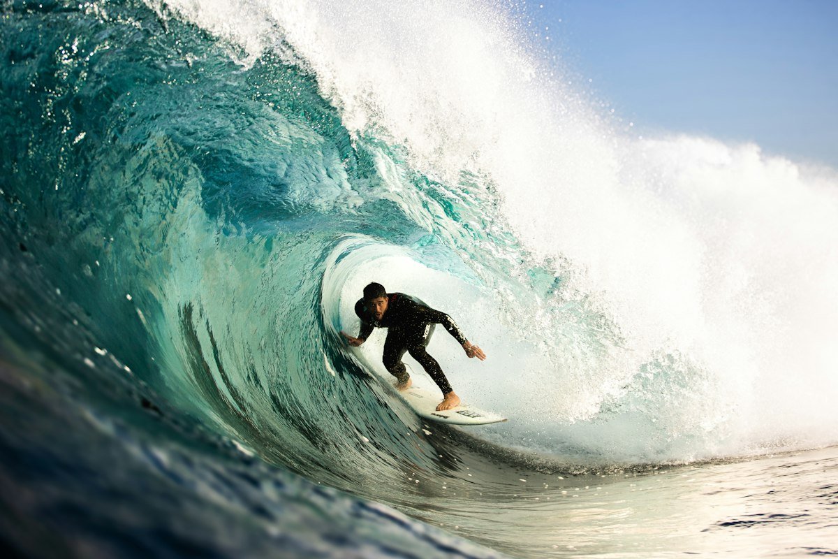 Surfer deep inside a green barrel
