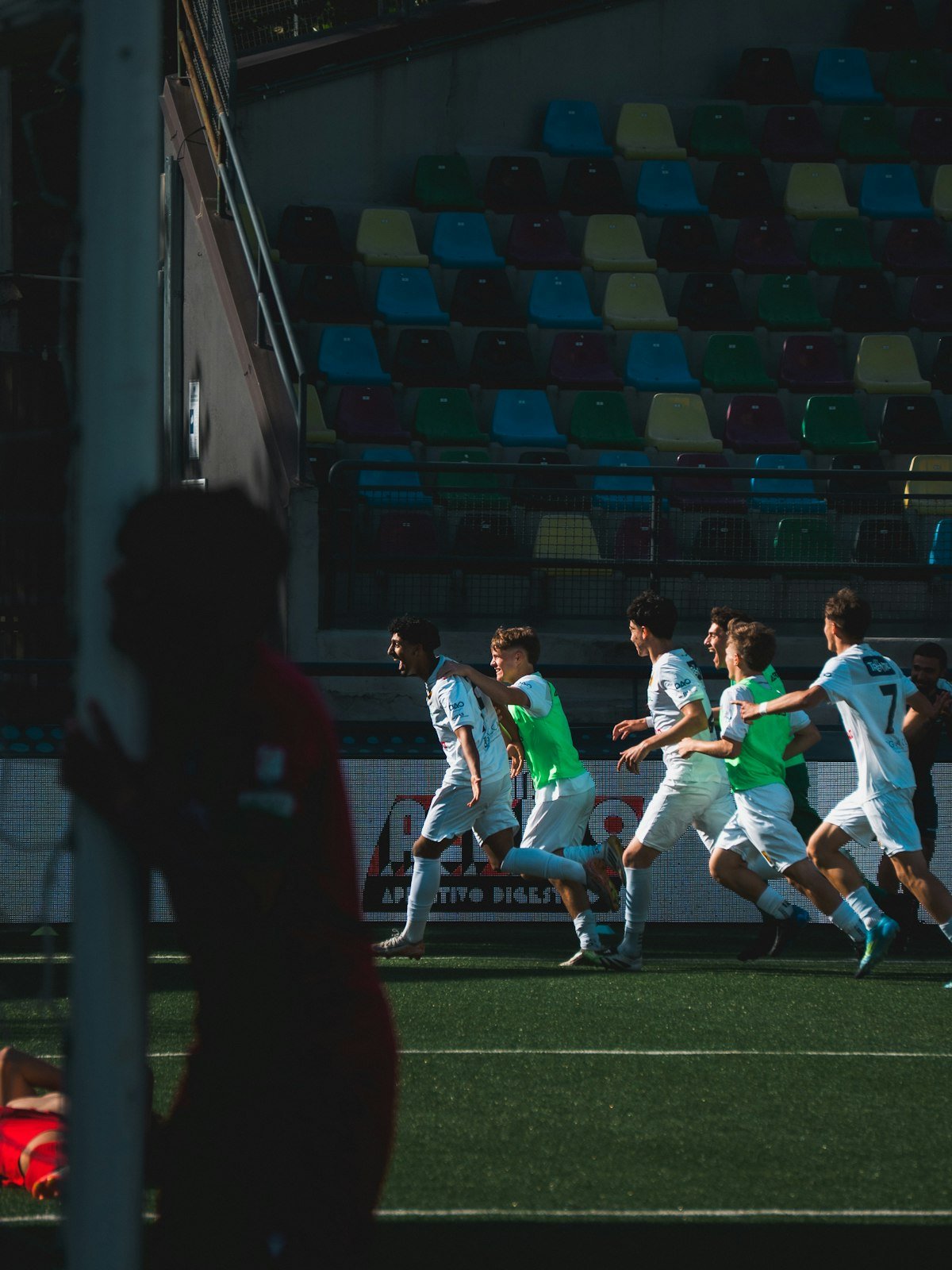 Players running under the floodlights